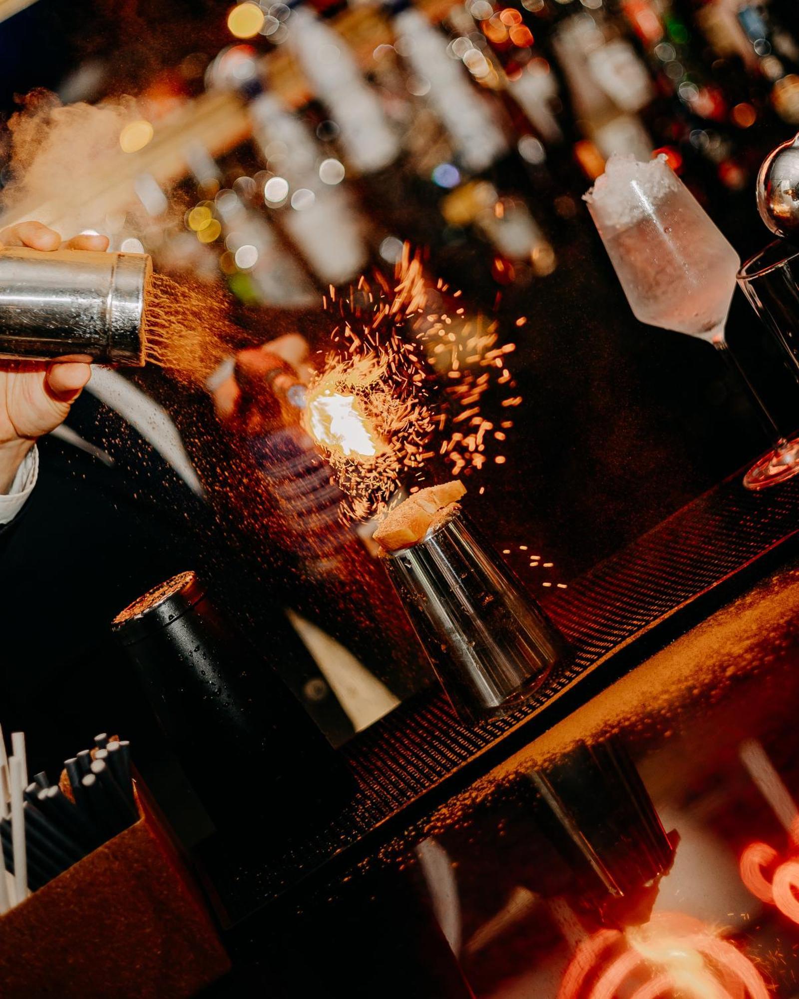 138 Liberdade Hotel Lisboa Dış mekan fotoğraf A bartender using a cocktail gun to make a flaming shot